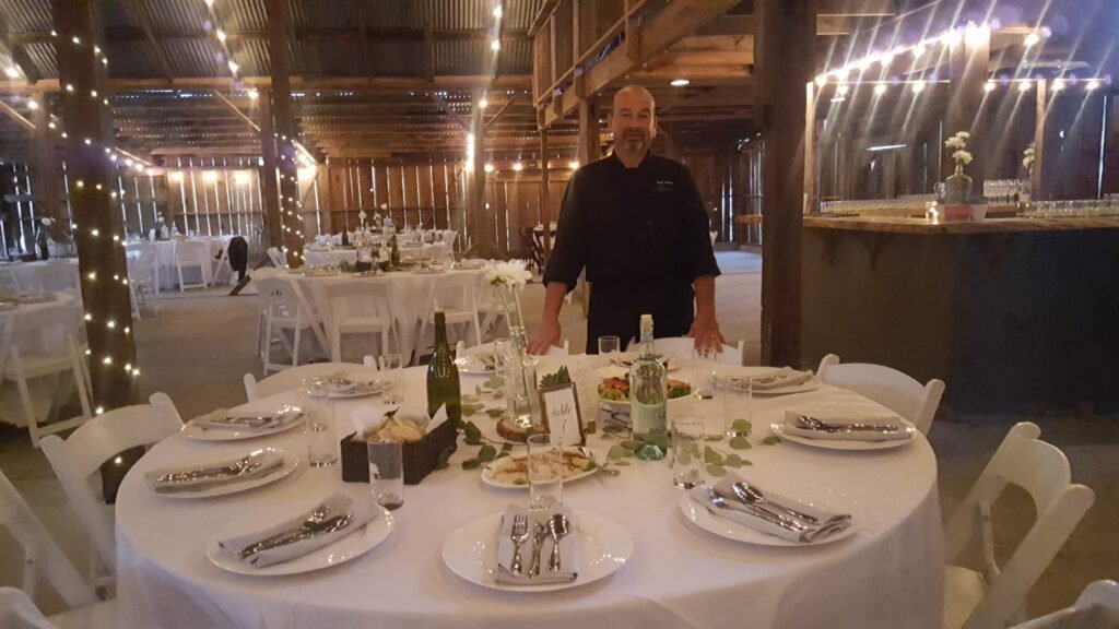 Chef Karim beside a wedding reception table